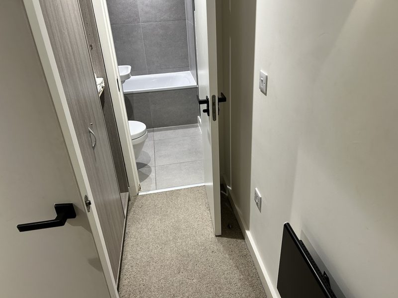 After: hallway cleared of laundry and vacuumed